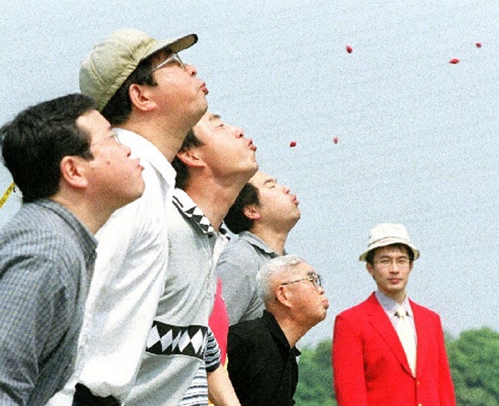  A group of citizens practice flying ume plum seeds   Chita City, Aichi Prefecture July Special Feature  Only One in Our Town  A group of citizens seriously practicing ume  plum  seed skipping on June 1, 2002  Special Feature 34 21G 22A .