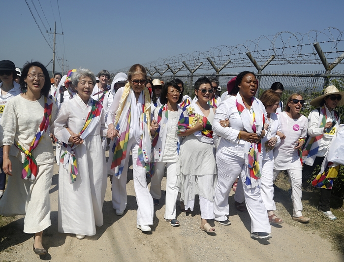 Women activists head to North Korea Crossing the Demilitarized Zone Women Cross DMZ Group, May 24, 2015 : U.S. activist Gloria Steinem  7th R, front row , Nobel Peace Prize laureates Mairead Maguire  3rd R, front row  from Northern Ireland and Leymah Gbowee  4th R, front row  from Liberia, walk with other activists toward the Imjingak Pavilion from the Unification Bridge along the military fences near the demilitarized zone  DMZ  separating the two Koreas, in Paju, north of Seoul, South Korea. About 30 women activists from around the world crossed the DMZ from North Korea to South Korea on Sunday by bus through the western land route instead of their original plan to walk through the truce village of Panmunjom by accepting Seoul s recommendation, to mark the International Women s Day for Disarmament.  Photo by Lee Jae Won AFLO   SOUTH KOREA 