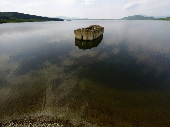 A Church Nestled in a Dam Tourist Attractions in Bulgaria Spring A wiew of submerged church  St. Ivan Rilski  at Zhrebchevo dam near the town of Tvardica, east of the Bulgarian capital Sofia, , May, 05, 2015. The Church of St. Ivan Rilski was once part of a village of Zapalnya, settled around 15th century but during the Zhrebchevo dam construction  in year 1965 the whole area and village have been submerging. The only thing left as evidence of the settlement are the ruins of this church wich every year in the Spring time surfaced as become one of most popular tourist attraction in the area. Sometimes when the waters cover the church over it becames and attraction for the scuba divers. Photo by: Petar Petrov Impact Press Group 
