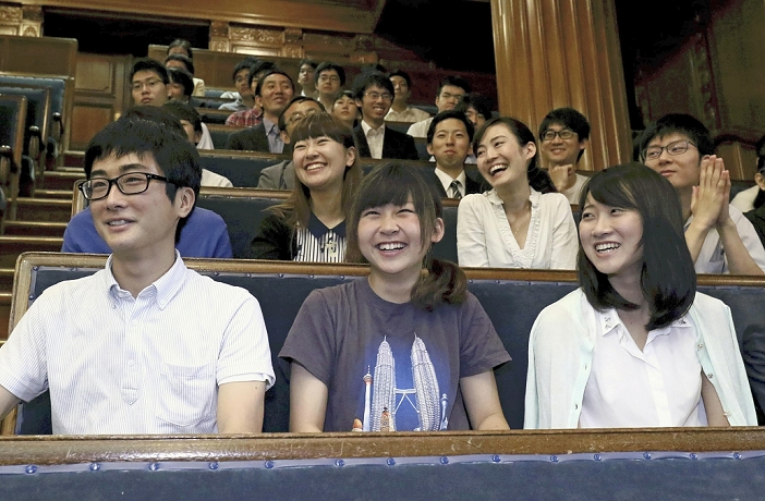Voting age lowered to 18 Revised Public Office Election Law passed. Students and others smile after the Diet passed a bill to amend the Public Offices Election Law to allow  18 year olds to vote  at a plenary session of the Upper House.