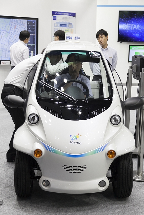Smart Community 2015 Comprehensive exhibition on new urban development An exhibitor shows to visitor an electric vehicle of Toyota   Ha:mo   at the Smart Community Japan 2015 in exhibition in Tokyo, Big Sight on June 17, 2015, Tokyo, Japan. The exhibition promotes both domestic and overseas next generation technologies. The last year 39,879 visitors attend the expo during three days. This year 233 enterprises and organizations will show their products from June 17th to 19th.  Photo by Rodrigo Reyes Marin AFLO 