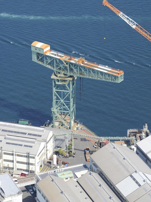 Large crane at Mitsubishi Nagasaki Shipyard   Machinery Works recommended to UNESCO for registration as an Icomos site Nagasaki City   Aerial view Giant cantilever crane  2:49 p.m., April 17, 2015, in Nagasaki City, Japan, from the head office helicopter   photo by Yuji Sakaguchi.  The International Council on Monuments and Sites  ICOMOS , an advisory body to UNESCO, has recommended the registration of the  Meiji Japan Industrial Revolution Heritage: Kyushu Yamaguchi and Related Areas   eight prefectures including Fukuoka Prefecture , which the government is seeking to have registered as a UNESCO World Cultural Heritage site.  The  Industrial Revolution Heritage  traces the history of Japan s heavy industry, and includes 23 properties  elements  in eight areas, from the reverberatory furnaces, shipyard and dock sites built by the Satsuma, Choshu and Saga clans at the end of the Edo period to the government run Yawata Steel Works, Miike coal mine and Mitsubishi Nagasaki Shipyard in the late Meiji period. The site also includes operating facilities not previously included in Japan s World Heritage list, such as the shipyard s large cranes, and the Hashima coal mine, famous as  Gunkanjima   Battleship Island .