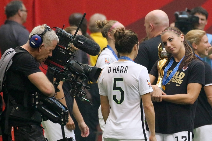 2015 FIFA Women s World Cup USA Wins 3rd title in 4 tournaments  R L  Alex Morgan, Kelley O Hara  USA , JULY 5, 2015   Football   Soccer : Alex Morgan of the United States holds the trophy as she celebrates with her teammate Kelley O Hara in front of a television camera after winning the FIFA Women s World Cup Canada 2015 Final match between United States 5 2 Japan at BC Place in Vancouver, Canada.  Photo by AFLO 