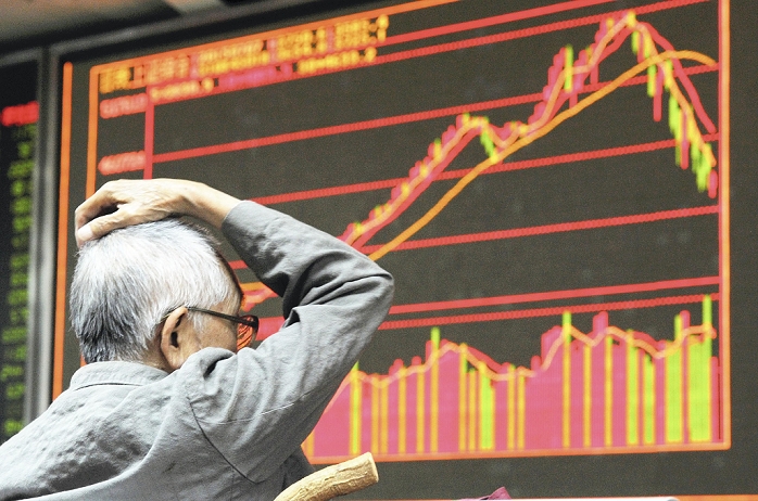 Economy, China Economic Slowdown 8 An investor holds his head in front of a stockbroker s price board showing falling prices  2:27 p.m., July 7, 2015, in Beijing   photo by Mitsuru Tamura, July 7, 2015