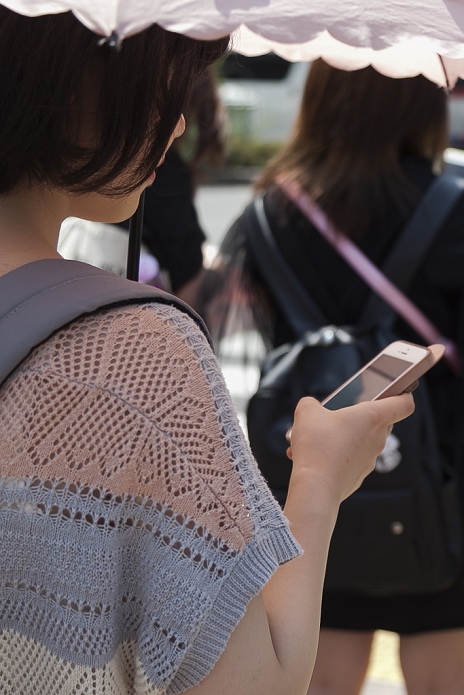 Modern Man and His Smartphone An inseparable part of life A woman looks at her smartphone in Shibuya shopping area on July 10, 2015, Tokyo, Japan.  Photo by Rodrigo Reyes Marin AFLO 