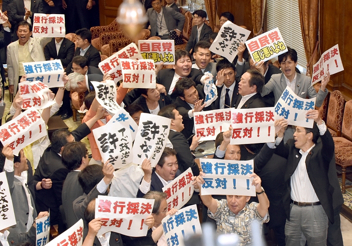 Security Bill forcibly voted on by the ruling party Passed by the Special Committee of the House of Representatives July 15, 2015, Tokyo, Japan   Opposition lawmakers holding protest signs as they try to obstruct proceedings during a vote on the government sponsored security related bills in a Diet lower house special committee on national security in Tokyo on Wednesday, July 15, 2015. The committee voted to approve the bills with the support of the ruling Liberal Democratic Party and its junior coalition partner Komeito. The bills will be put to a vote in a Diet plenary session as early as July 16, after which it will be sent to the upper house. The bills, when enacted, will allow Japan to exercise its right to collective self defense.   Photo by Natsuki Sakai AFLO  AYF  mis 