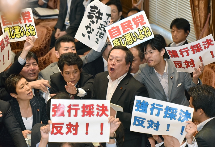 Security Bill forcibly voted on by the ruling party Passed by the Special Committee of the House of Representatives July 15, 2015, Tokyo, Japan   Opposition lawmakers holding protest signs surround the chairman as they try to obstruct proceedings during a vote on the government sponsored security related bills in a Diet lower house special committee on national security in Tokyo on Wednesday, July 15, 2015. The committee voted to approve the bills with the support of the ruling Liberal Democratic Party and its junior coalition partner Komeito. The bills will be put to a vote in a Diet plenary session as early as July 16, after which it will be sent to the upper house. The bills, when enacted, will allow Japan to exercise its right to collective self defense.   Photo by Natsuki Sakai AFLO  AYF  mis 