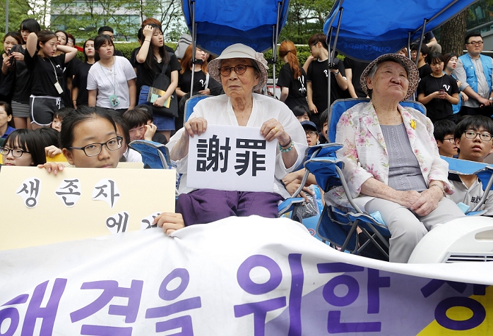 Wednesday Rally  to Protest Comfort Women Held every Wednesday in Seoul Anti Japan Protest, Jul 22, 2015 : South Korean Kim Bok Dong  C, 90  and Gil Won Ok  R, 88 , who were so called comfort women and insists that they had been forced to become sex slaves for Japanese Army during the World War II, attend the 1188th weekly  Wednesday Demonstration  in front of the Japanese Embassy in Seoul, South Korea. Hundreds of people attended the demonstration on Wednesday to demand Japan acknowledge state responsibility for the sex slaves. Japan insists the issue was settled under the normalization treaty of 1965, according to local media. A sign  C  reads,  Apology .  Photo by Lee Jae Won AFLO   SOUTH KOREA 