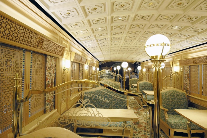 JR Kyushu s  Aru Train  Unveiled Modeled after a fantastic prewar luxury coach The interior of JR Kyushu s  Aru Train  train, which was unveiled to the press. The train features a luxurious interior  10:57 a.m., July 17, 2015, in Kokurakita ku, Kitakyushu City . On July 17, JR Kyushu unveiled its new sightseeing train  Aru Train  with a theme of sweets at the Kokura General Rolling Stock Center in Kitakyushu City. The exterior of the train features an arabesque pattern based on gold, stained glass windows, and an interior that uses a lot of wood on the ceiling and floor, giving it a luxurious feel.  The train will begin service between Oita and Hita Stations in Oita Prefecture on August 8.  The train consists of two cars and has a capacity for 38 passengers. The design is based on a model of a Meiji era luxury train created by Shintaro Hara, a collector of model trains who passed away last year.  The interior of the train is carpeted with table seating. There is also a kitchen where sweets are prepared, and Hara s original model is displayed.