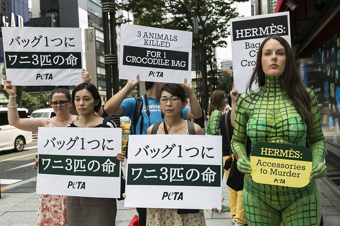 Criticized for handling of crocodiles PETA protests against Hermes A body painted model with other members from PETA  the People For The Ethical Treatment of Animals organization  protest outside the luxury Hermes store in the upscale Ginza shopping district on July 30th, 2015 in Tokyo, Japan. PETA claims that Hermes bags and accessories use crocodiles and alligators that are kept in poor conditions and still conscious when being cut open. Japan is a big market for Hermes and luxury brands with many Asian tourists and Japanese visiting Ginza for shopping.  Photo by Rodrigo Reyes Marin AFLO 