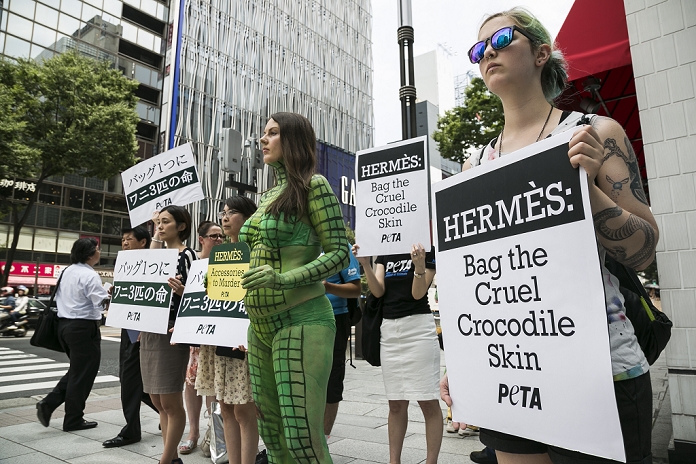 Criticized for handling of crocodiles PETA protests against Hermes A body painted model with other members from PETA  the People For The Ethical Treatment of Animals organization  protest outside the luxury Hermes store in the upscale Ginza shopping district on July 30th, 2015 in Tokyo, Japan. PETA claims that Hermes bags and accessories use crocodiles and alligators that are kept in poor conditions and still conscious when being cut open. Japan is a big market for Hermes and luxury brands with many Asian tourists and Japanese visiting Ginza for shopping.  Photo by Rodrigo Reyes Marin AFLO 