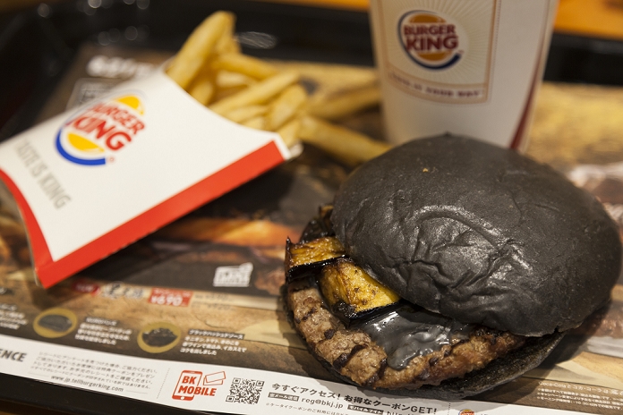 The Evolution of the  Black Burger  Available this year from Barkin Burger King s new black burger   Kuro Shogun   went on sale on August 21, 2015, Tokyo, Japan. The chain s two new black burgers use bamboo charcoal infused buns and cheese, Black Hashed Sauce  a mix of red wine, squid ink, onions, tomato and crushed garlic , and slices of grilled eggplant. In July Burger King launched two red burgers in another Japan only colored burgers promotion. The two new black burgers are the Kuro Shogun costing 690 JPY  5.59 USD  and the Kuro Taisho costing 590 JPY  4.78 USD . They will be on sale for a limited time in Burger King s Japanese stores from August 21st.  Photo by Rodrigo Reyes Marin AFLO 