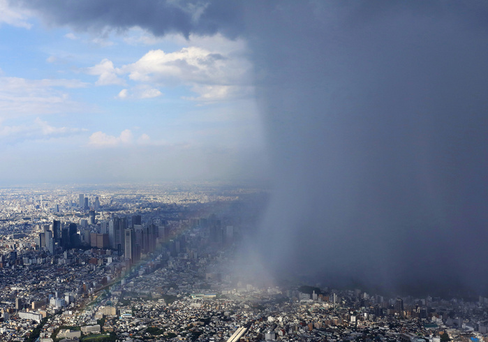 Central Tokyo covered by localized rain clouds Central Tokyo  right  is locally covered by rain clouds amid blue skies around it. The Shinjuku subcenter on the left is clear of clouds, photographed by Susumu Yamamoto from the head office helicopter at 2:48 p.m. on September 4, 2015, in Tokyo.