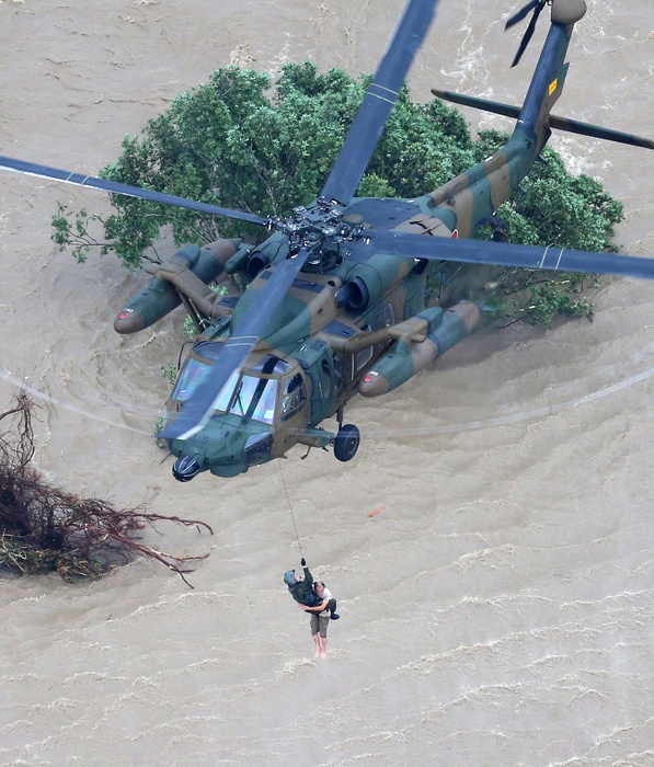 Typhoon No. 18 Crosses the Archipelago Record rainfall in Ibaraki and Tochigi A person is rescued by a Self Defense Forces helicopter after heavy rain caused the Kinugawa River to burst, in Joso City, Ibaraki Prefecture, Japan, at 3:12 p.m. on September 10, 2015, photo by Naoaki Hasegawa from a HQ helicopter.