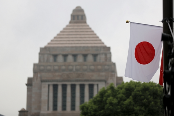 Security Bill, the offensive and defense are at a standstill Daily demonstrations in front of the Diet A Japanese flag flutters in front of the parliament during a demonstration against the passage of Japan s Prime Minister Shinzo Abe s security bills in Tokyo on Friday, September 18, 2015.  Photo by Yuriko Nakao AFLO 
