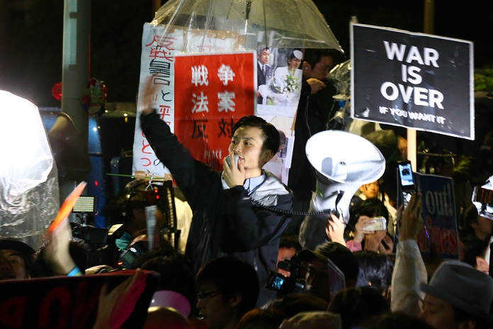Japan s security bills in full swing Daily demonstrations in front of the National Diet Aki Okuda, a leader of the Students Emergency Action for Liberal Democracy  SEALDs  turned out in the rain on Thursday to protest outside the National Parliament as opposition politicians inside also tried to block controversial security bills on September 17, 2015, in Tokyo, Japan. Inside parliament the security bills that could allow troops to fight overseas for first time since World War Two were passed by a legislative committee amid pushing and shoving, and now only require approval in the upper house. Those opposing the bills still believe that they violate the constitution and could sink Japan into US conflicts. Protests have occurred almost daily over the past weeks outside the Diet building against Prime Minister Shinzo Abe and his popularity has also suffered as a result.  Photo by AFLO 