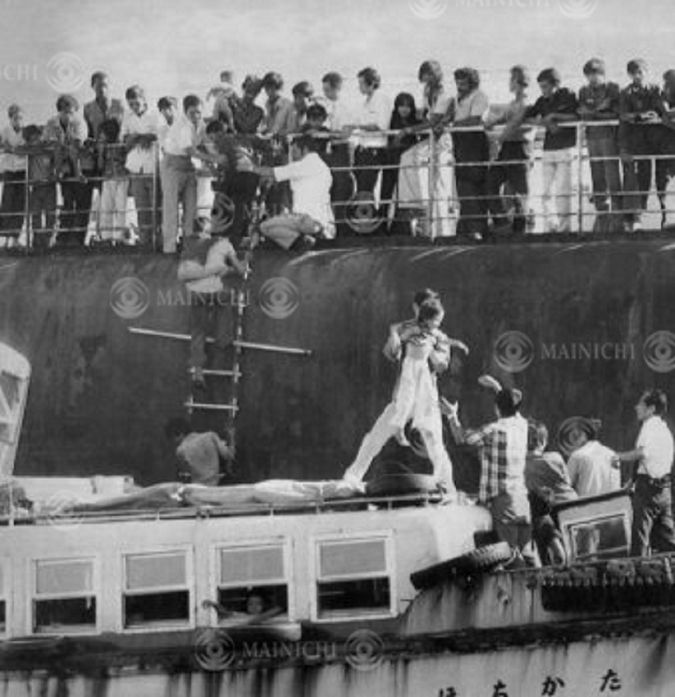 Vietnam, Refugees  August 1979  Vietnamese refugees transferring from a Greek tanker to a toll boat, off Sakai, Osaka Bay, August 1979.