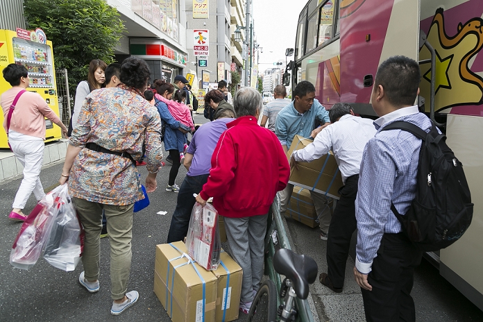 Chinese  Bakuhatsu Tour Visiting Japan for the National Day holiday Chinese tourists hold their shoppings in Shinjuku shopping district during the China National Day Golden Week holiday on October 5, 2015, Tokyo, Japan. The National Day Golden Week runs from October 1st to 7th, and Japan is the second position most popular overseas destination for Chinese tourists. According to CEIC Data, the numbers of Chinese tourists traveling aboard will increase from 116 million in 2014 to about 242 million in 2024, and visits to Japan are projected to rise taking advantage of a weak yen.  Photo by Rodrigo Reyes Marin AFLO 