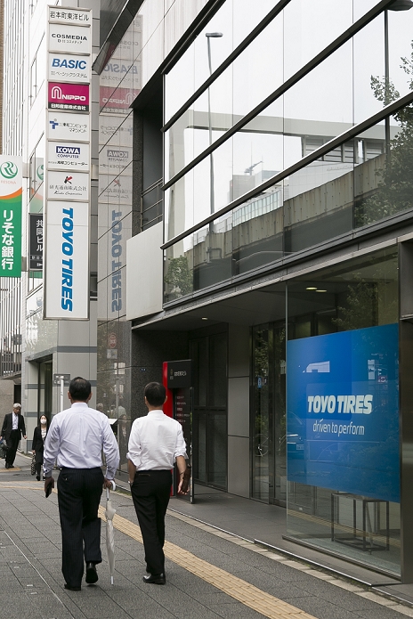 Toyo Tire   Rubber Co. Fraud also discovered in  anti vibration rubber Pedestrians walk past the Toyo Tire   Rubber Co. building on October 16, 2015, Tokyo, Japan. Toyo Tire   Rubber Co. admitted that the performance data and quality tests for some rubber products was manipulated during a press conference at its headquarters in Osaka on Wednesday. The trouble potentially affects 87,804 products delivered to 18 companies and Toyo Tire will contact the companies and replace the products if necessary. Two of the companies affected are Japan s major rail operators Central Japan Railway Co. and West Japan Railway Co. although neither has reported any problems.  Photo by Rodrigo Reyes Marin AFLO 