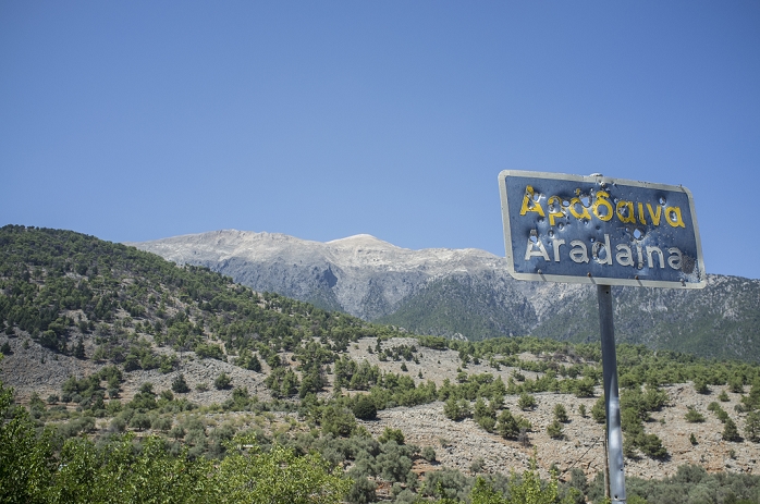 Bullet ridden sign, Aradaina, Crete