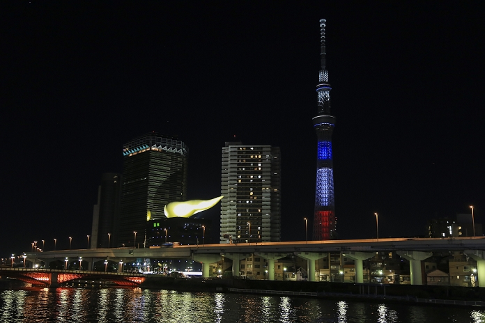 Paris Terrorist Attacks. Mourning the Victims in Tokyo Tokyo Skytree is lighted up with the colors of the French flag to show solidarity in Tokyo, Japan on November 15, 2015 after the terrorist attacks in Paris on last Friday. In a gesture of condolence and solidarity with the French people the Chief Cabinet Secretary Yoshihide Suga, Tokyo Governor Yoichi Masuzoe and local Japanese and French attended a special ceremony at the Embassy of France in Tokyo. After the event a small group met outside Shibuya station to sing the Marseillaise. Tokyo also paid respect by illuminating Tokyo Tower and Tokyo Skytree in blue, white and red, the colors of the French flag.  Photo by Rodrigo Reyes Marin AFLO 