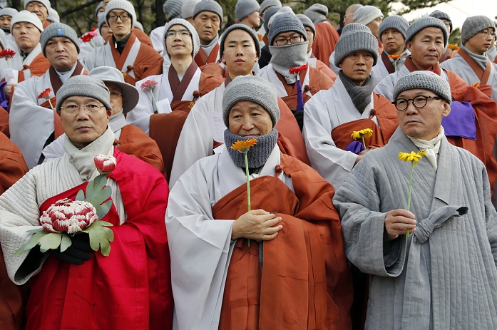 Massive Rally in  Masks  South Korea Protest against the Park Geun hye Administration Protest against Park Geun Hye, Dec 5, 2015 : Holding flowers, Buddhist monks attend an anti government rally in Seoul, South Korea. The  People s Camp for Rising Up and Fighting , representing various groups of farmers, students, workers and the poor, demonstrated on December 5, 2015 to oppose Park s regime to change the labor market which protesters insist, will allow easier layoff and more temporary workers and to monopolize the authorship of history textbooks. People wore masks at the rally to denounce Park who recently compared local protestors in masks to ISIS. The organizer said 50,000 people participated in the demo, while the police estimated that 14,000 attended.  Photo by Lee Jae Won AFLO   SOUTH KOREA 