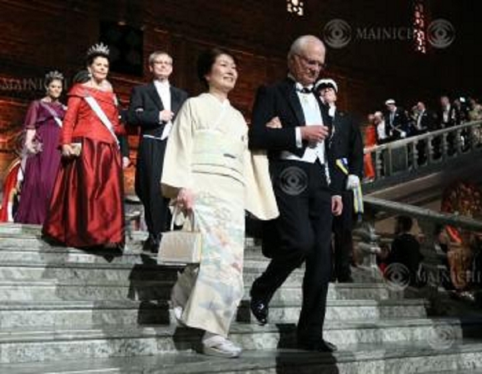 Nobel Prize 2015. Dinner in Stockholm Michiko  foreground , wife of Takaaki Kajita, director of the Institute for Cosmic Ray Research at the University of Tokyo, is escorted by King Carl XVI Gustaf of Sweden at a dinner party after the Nobel Prize ceremony, at Stockholm City Hall, December 10, 2015, 7:08 p.m.  representative photo 