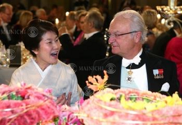 Nobel Prize 2015. Dinner in Stockholm Michiko, wife of Takaaki Kajita, director of the Institute for Cosmic Ray Research at the University of Tokyo, exchanges words with King Carl XVI Gustaf of Sweden  right  at a dinner party after the Nobel Prize ceremony, at Stockholm City Hall, December 10, 2015, 7:24 PM  representative photo .