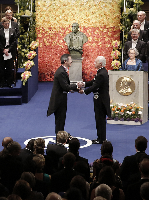 Nobel Prize 2015. Award ceremony in Stockholm Takaaki Kajita, director of the Institute for Cosmic Ray Research at the University of Tokyo, receives a physics medal and certificate from King Carl XVI Gustaf of Sweden  right  at the Nobel Prize ceremony at the Concert Hall in Stockholm, December 10, 2015, 4:54 PM  representative photo .