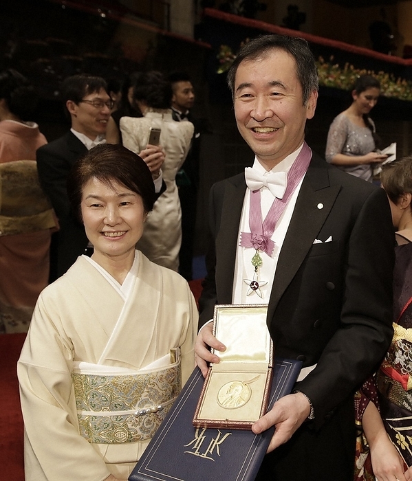 Nobel Prize 2015. Award ceremony in Stockholm Takaaki Kajita, director of the Institute for Cosmic Ray Research at the University of Tokyo, smiles with his wife Michiko  left  and his medal after the Nobel Prize ceremony at the Concert Hall in Stockholm, December 10, 2015, 5:47 PM  representative photo .