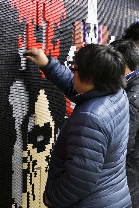 Massive Monster Attack in Shinjuku  Unblock and defeat them  Dragon Quest fans collect blocks from a giant Lego wall mural on January 28, 2016 in Tokyo, Japan. The mural is part of a promotion in Shinjuku Station to celebrate the release of new game Dragon Quest Builders. The 80 meter mural was made with 180,000 Lego blocks and fans were allowed to remove blocks to reveal a secret poster behind. Some blocks contained QR codes allowing fans to access exclusive content.  Photo by Rodrigo Reyes Marin AFLO 
