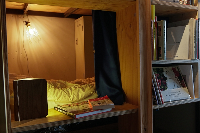 Into a dream while reading  Bookstore where you can stay overnight  in Ikebukuro The Book and Bed designer hostel in Ikebukuro on February 5, 2016 in Tokyo, Japan. This new Tokyo hostel was designed on the concept of staying overnight in a bookstore. It includes 30 bed compartments tucked into a wall of bookshelves and a communal reading space. Sleeping compartments cost from JPY 3,000   JPY 4,000 per night  approx. US  30 40  and the hostel managers want to promote the idea of dozing off comfortably whilst reading a book. The new hostel next to Ikebukuro JR rail station has an English homepage and could be a good solution for visiting backpackers.  Photo by Martin Hladik AFLO 
