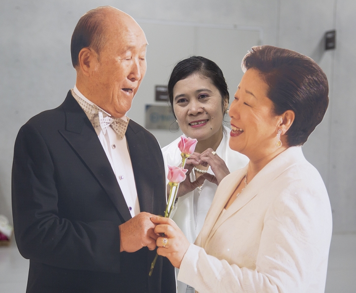Unification Church s Joint Wedding Ceremony  February 20, 2016  Unification Church s mass wedding, Feb 20, 2016 : A believer of the Unification Church takes a souvenir photo between pictures of Han Hak Ja  R , widow of the late Rev. Moon Sun Myung  L , founder of the Unification Church during a mass wedding ceremony of church at the Cheong Shim Peace World Center in Gapyeong, about 60 km  37 miles  east of Seoul, South Korea.The church said about 3,000 couples from more than 60 countries participated in the mass wedding in Gapyeong and other 12,000 couples attended in the wedding ceremony through live streamed broadcast, which was organized by Han Hak Ja, widow of the late Rev. Moon Sun Myung, founder of the Unification Church.   Photo by Lee Jae Won AFLO   SOUTH KOREA 