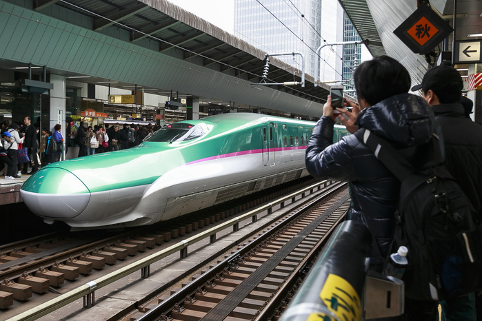 Hokkaido Shinkansen Line Opens Tokyo   Shin Hakodate Hokuto in 4 hours People take pictures of the Hayabusa Shinkansen  bullet train  in Tokyo Station on March 26, 2016, Tokyo, Japan. The Hayabusa shinkansen connects Tokyo with the northern island of Hokkaido via the 53.85 km long Seikan Tunnel. Previously Japan s bullet train only operated as far as Aomori but the new rail link now goes to Shin Hakodate Hokuto Station in Hokkaido with a further extension planned to Sapporo by 2030. A one way ticket costs 22,690 yen  200 UDS  from Tokyo to Shin Hakodate Hokuto and the fastest trains will take 4 hours and 2 minutes for the journey.  Photo by Rodrigo Reyes Marin AFLO 