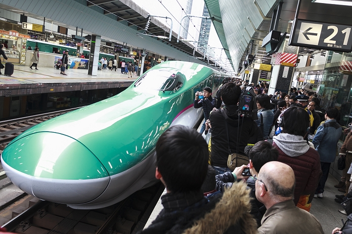 Hokkaido Shinkansen Line Opens Tokyo   Shin Hakodate Hokuto in 4 hours People take pictures of the Hayabusa Shinkansen  bullet train  in Tokyo Station on March 26, 2016, Tokyo, Japan. The Hayabusa shinkansen connects Tokyo with the northern island of Hokkaido via the 53.85 km long Seikan Tunnel. Previously Japan s bullet train only operated as far as Aomori but the new rail link now goes to Shin Hakodate Hokuto Station in Hokkaido with a further extension planned to Sapporo by 2030. A one way ticket costs 22,690 yen  200 UDS  from Tokyo to Shin Hakodate Hokuto and the fastest trains will take 4 hours and 2 minutes for the journey.  Photo by Rodrigo Reyes Marin AFLO 