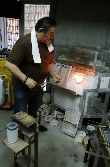 Japanese Occupation Edo Fu ring  March 31, 2016  March 31, 2016, Tokyo, Japan   Masayoshi Shinohara heats a blob of glass in the furnace before blowing it into the shape of a wind bell at his workshop in downtown Tokyo on Thursday, March 31, 2016. Traditional Japanese wind chimes have captured the hearts of Japanese with their beautiful sounds since the 18th century when Dutch glass making techniques were first introduced to Japan. One of the characteristics of the authentic Japanese glass wind bells is that the painting is done from inside in order to keep the colors from fading.  Photo by Haruyoshi Yamaguchi AFLO  VTY  mis 