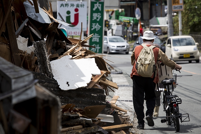 Kumamoto Earthquake Major damage in Mashiki Town KUMAMOTO, JAPAN   APRIL 22: An earthquake survivor is seen through the wreckage of houses on April 22, 2016 in Mashiki town, Kumamoto, Japan. A series of earthquakes as big as magnitude 7.3 hit Kumamoto prefecture leaving 48 people dead and 263 seriously injured. Over 80,000 people were evacuated from their homes as a result.  Photo by Richard Atrero de Guzman AFLO 