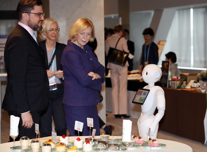 G7 Science and Technology Ministers Meeting Held in Tsukuba City May 17, 2016, Tsukuba, Japan   German Education and Research Minister Johanna Wanka  C  looks at sweets on the table, while Softbank s humanoid robot Pepper  R  looks at her at a coffee break at the G7 Science and Technology Ministers  Meeting in Tsukuba in Ibaraki prefecture on Tuesday, May 17, 2016.   Photo by Yoshio Tsunoda AFLO  LWX  ytd 