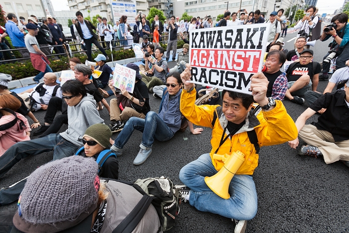 Kawasaki Hate Demonstration. Cancelled immediately after departure An anti racists protestor holds a placard during a demonstration against discrimination of Korean residents in Kawasaki city on June 5, 2016, Kanagawa Prefecture, Japan. The Yokohama District Court Kawasaki branch granted a provisional injunction to prevent anti Korean demonstrations at public parks in this city on Thursday. The court s decision came after Kawasaki Municipal Government prohibited a request to organise hate speeches in public and events against Korean residents. Japan recently enacted its first ever anti hate speech law.  Photo by Rodrigo Reyes Marin AFLO 