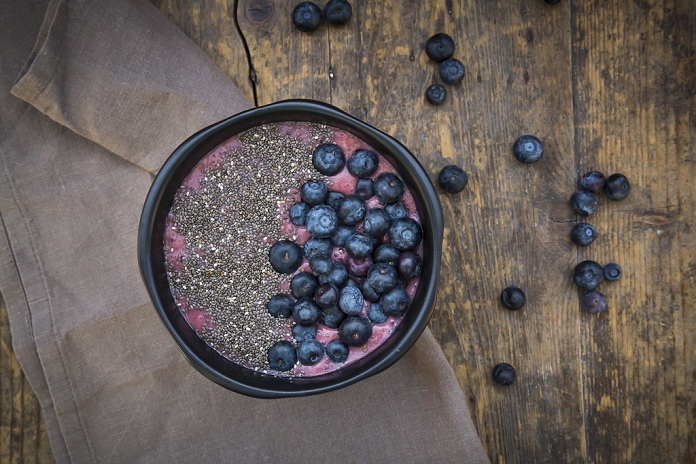 Blueberry smoothie with chia seeds in bowl, fresh blueberries