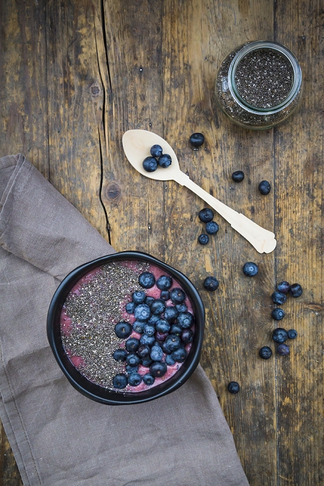 Blueberry smoothie with chia seeds in bowl, fresh blueberries