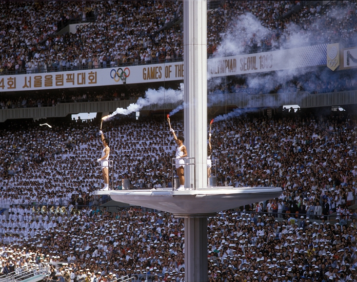 1988 Seoul Olympics Opening Ceremony General view, SEPTEMBER 17, 1988 : The final torchbearers Chung Sun Man, Sohn Mi Chung, and Kim Won Tak prepare to light the Olympic cauldron during the Opening Ceremony of the 1988 Seoul Olympics Summer Games in the Olympic Stadium, Seoul Sports Complex, South Korea. Some doves, released to symbolise world peace, were resting on the cauldron s rim and were burned alive when it was lit.  Photo by AFLO 
