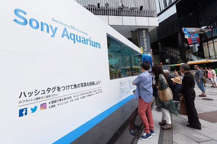 Annual Aquarium in Ginza Creating a momentary coolness  July 16, 2016  People look at numerous tropical fish from Okinawa swimming inside a 14 tonne tank set up outside Sony Building in Ginza on July 16, 2016, Tokyo, Japan. The annual Sony Aquarium shows off 24 different species from Japan s southern islands in partnership Okinawa Churaumi Aquarium. This year Sony Building celebrates its 50th anniversary with some 500 fish from July 15 to August 28, 2016.  Photo by Rodrigo Reyes Marin AFLO 