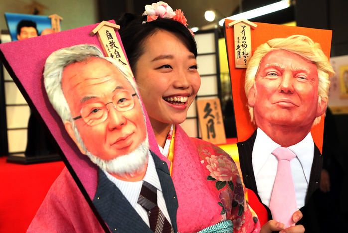 Year end annual  KARAKANEI HAKOITA   changing shuttlecock board  Faces of 2016 December 7, 2016, Tokyo, Japan   An employee of Japanese doll maker Kyugetsu in kimono dress displays ornamental wooden rackets or  hagoita  decorated with depiction of U.S. President elect Donald Trump and Japanese Nobel laureate Yoshinori Ohsumi for this year s news makers at the company s showroom in Tokyo on Wednesday, December 7, 2016. A hagoita is a wooden paddle used to play the new year hanetsuki game, where two players hit a shuttlecock back and forth.   Photo by Yoshio Tsunoda AFLO  LWX  ytd 