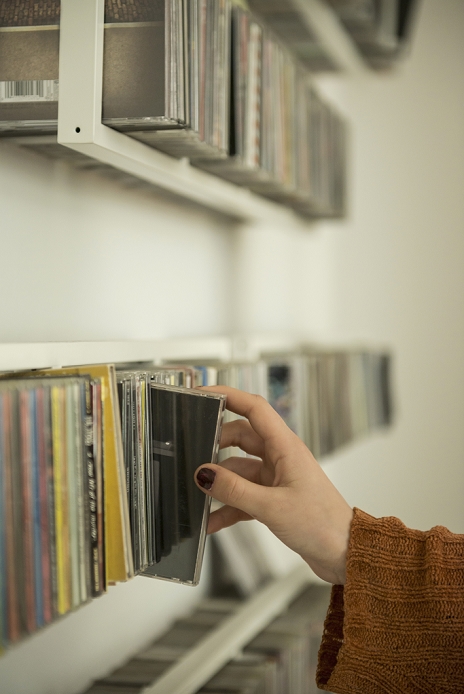 Close-up of a woman hand picking a cd from shelf, Munich, Bavaria, Germany