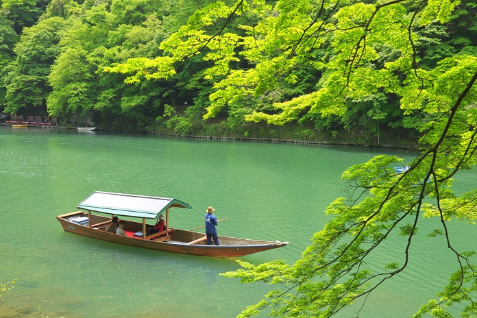 Arashiyama and Yakatabune (houseboat) in the fresh green of Hozukyo Gorge, Kyoto, Japan