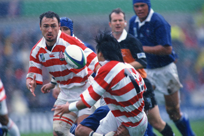 1999 Rugby World Cup First round league Pool D Tsutomu Matsuda, Greg Smith  JPN  OCTOBER 3, 1999   Rugby : Tsutomu Matsuda of Japan passes the ball to Greg Smith during the IRB World Cup 1999 Pool D match between Japan 9 43 Samoa at Racecourse Ground in Wrexham, Wales.   Photo by Jun Tsukida AFLO SPORT   0003 .