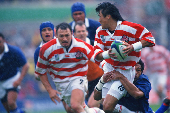 1999 Rugby World Cup First round league Pool D Tsutomu Matsuda  JPN  OCTOBER 3, 1999   Rugby : Tsutomu Matsuda of Japan is tackled by Samoa player during the IRB World Cup 1999 Pool D match between Japan 9 43 Samoa at Racecourse Ground in Wrexham, Wales.   Photo by Jun Tsukida AFLO SPORT   0003 .