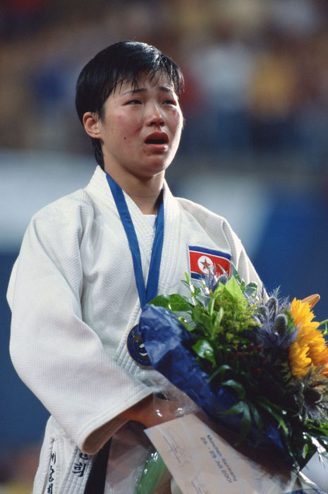 Sun Hui Kye (PRK), 
JULY 28, 2001 - Judo : 
Sun Hui Kye of North Korea celebrates on the podium with gold medal after winning the 22th World Judo Championships 2001 Women's -52kg class at Olympiahalle in Munich, Germany. 
 (Photo by Jun Tsukida/AFLO SPORT) [0003]