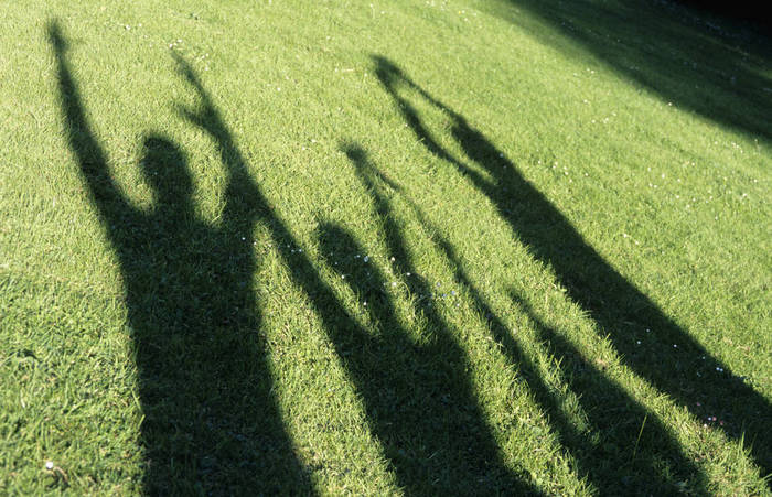WESTF01175 Human shadows on grass, raising arms